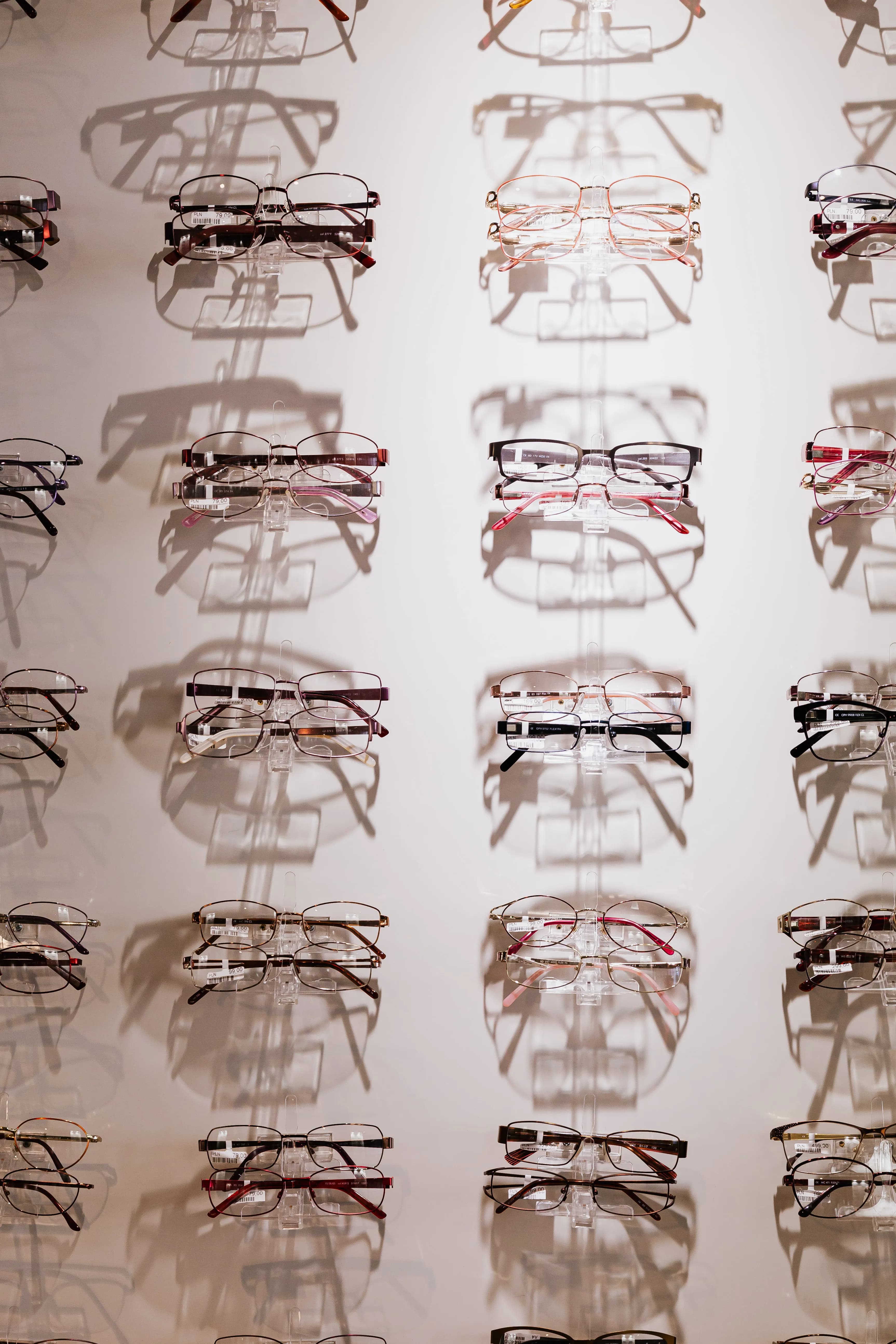 Rows of eyeglass frames on a display wall